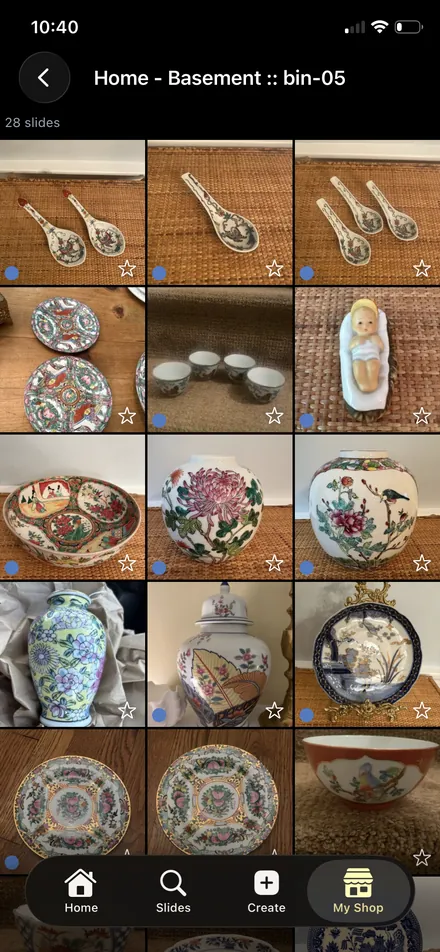 The contents of bin-05 in the Carousel Shop AI iPhone app, a grid of 28 items of Asian porcelain including spoons, ginger jars, bowls and plates.